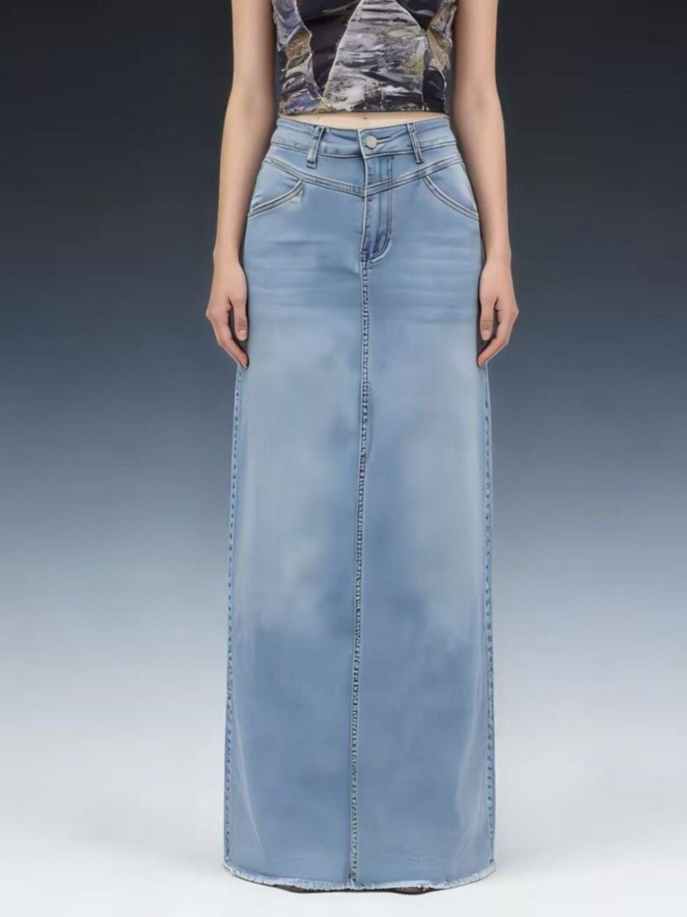 Raw hem maxi denim skirt with front button closure in 85% cotton 15% polyester blend.