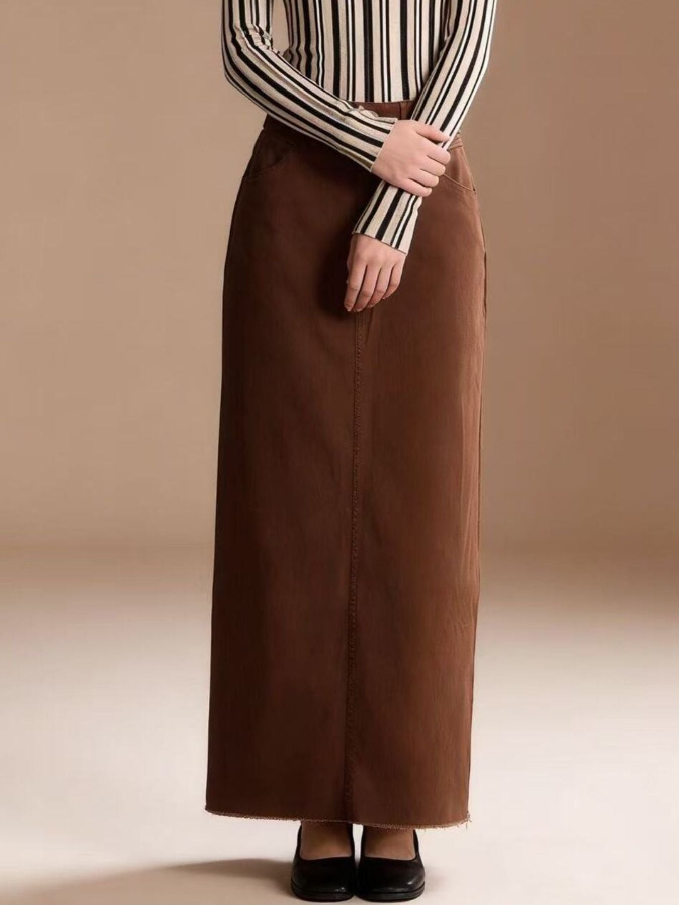 Brown raw-hem maxi denim skirt with front button closure, 85% cotton 15% polyester blend