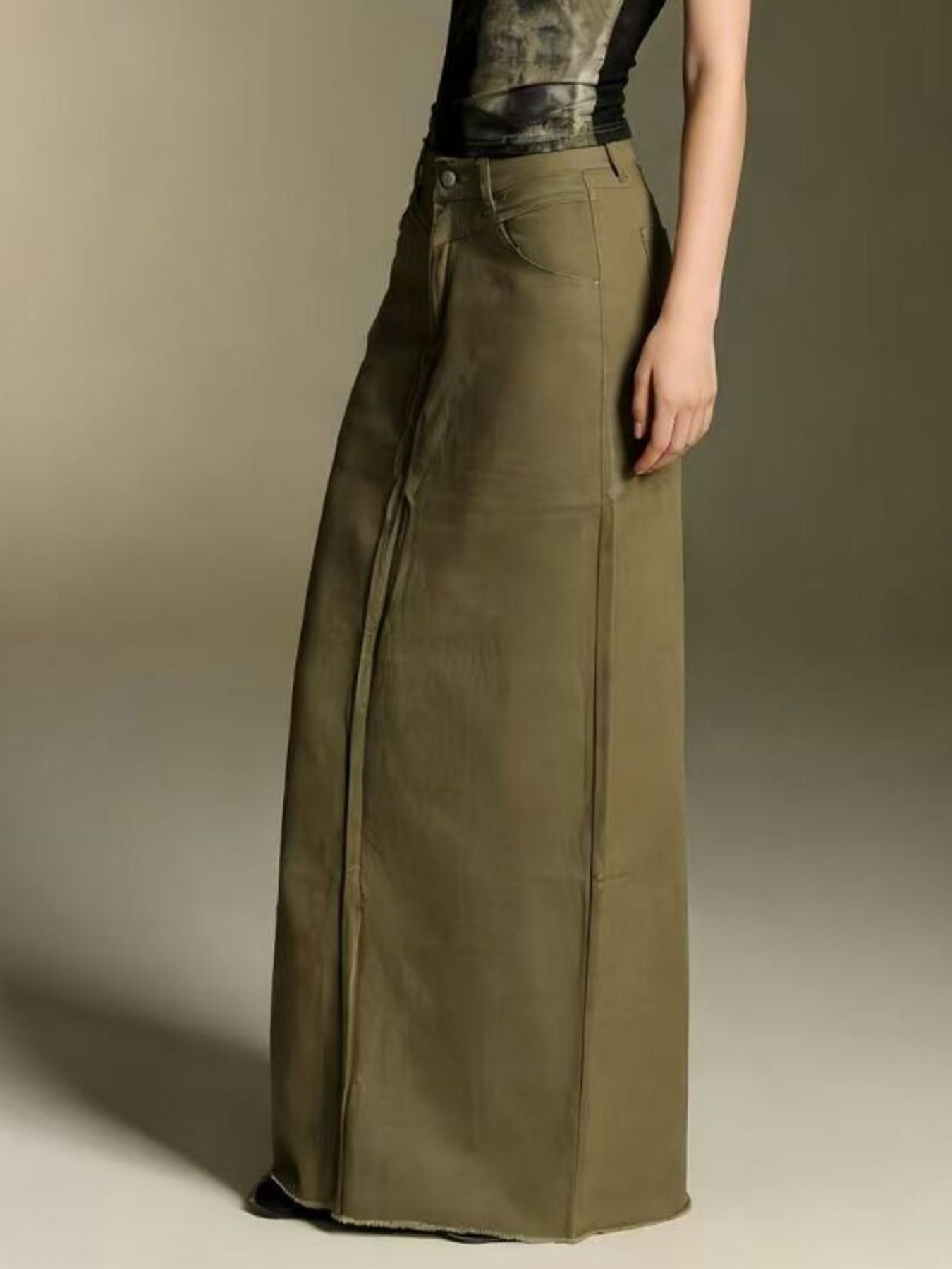 Olive raw-hem maxi denim skirt with front button closure, 85% cotton 15% polyester blend.