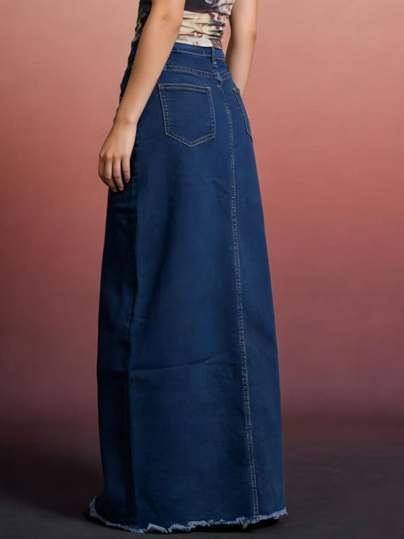 Blue raw-hem maxi denim skirt with front button closure, back pockets, 85% cotton / 15% polyester.