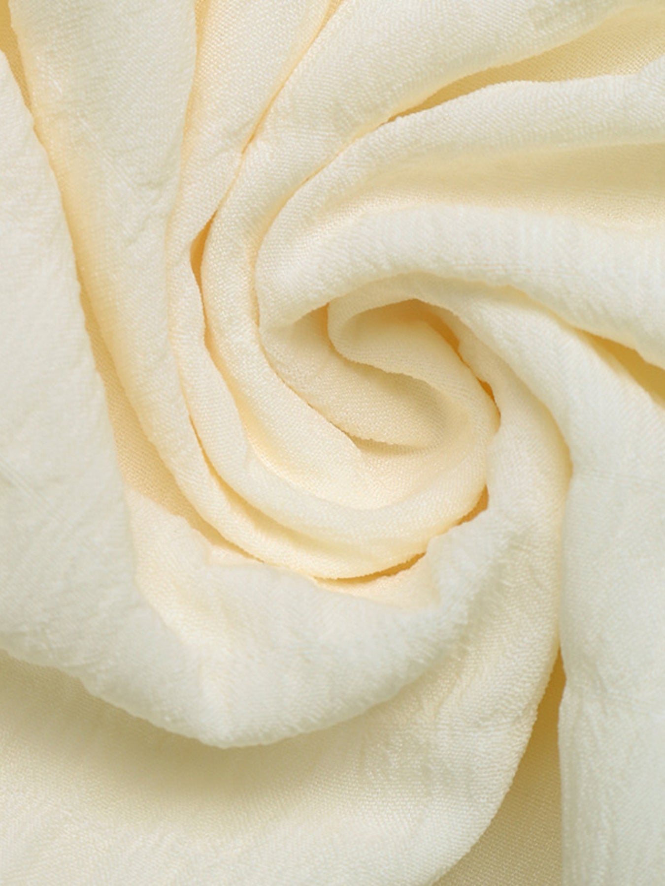 Cream fabric close-up for Smocked Spaghetti Strap Casual Dress; polyester/elastane blend.