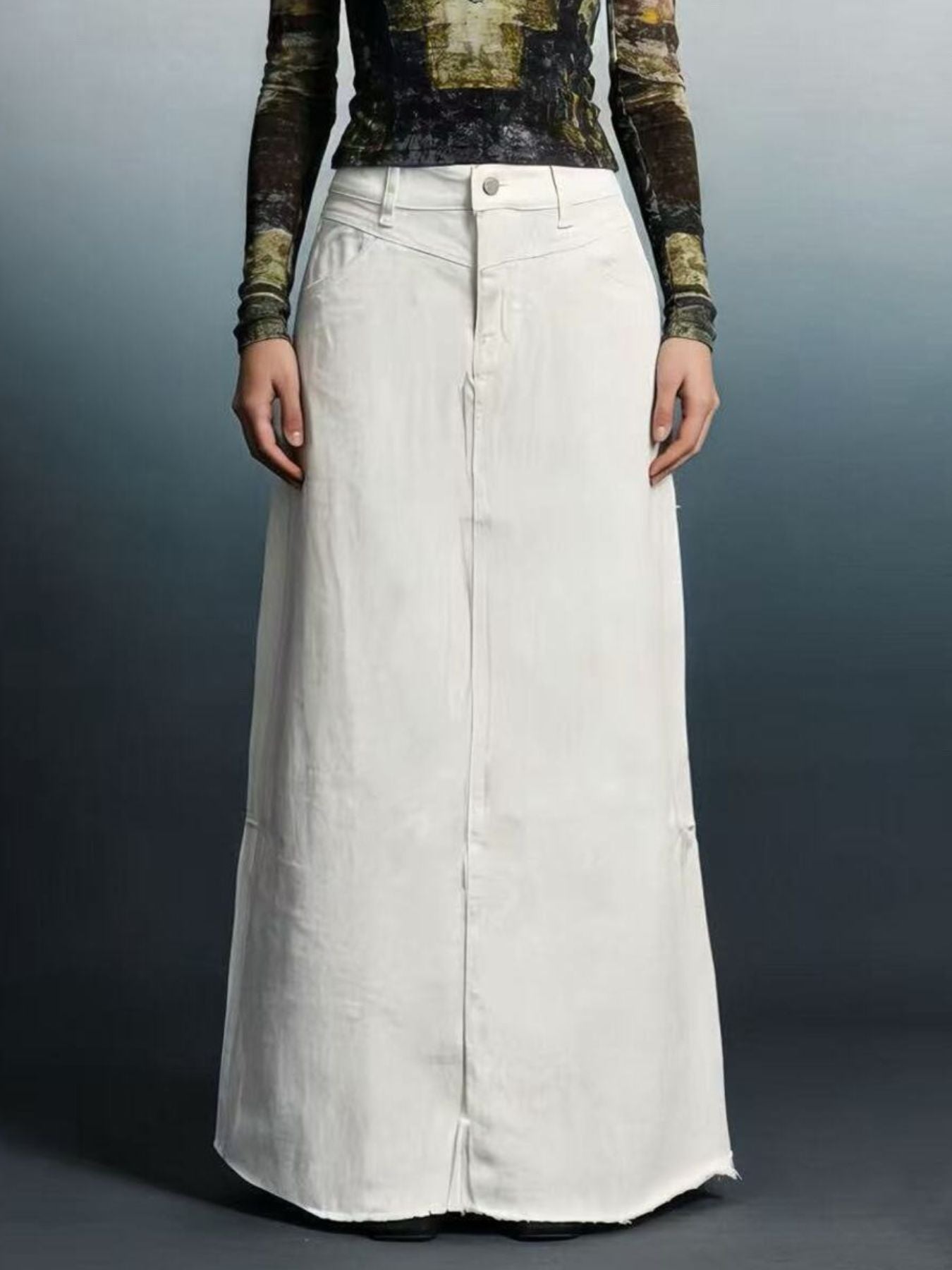 Raw-hem maxi denim skirt with front button closure in a light 85% cotton, 15% polyester blend.